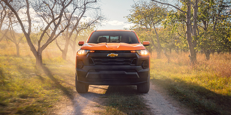 A 2026 Chevrolet Colorado ZR2 driving along a dirt road in Laurel, MD, showcasing its rugged design and off-road capability.